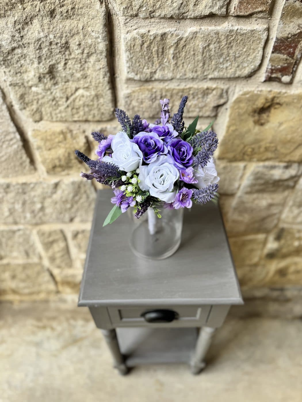 A violet and white arrangement by Violet Rays Co